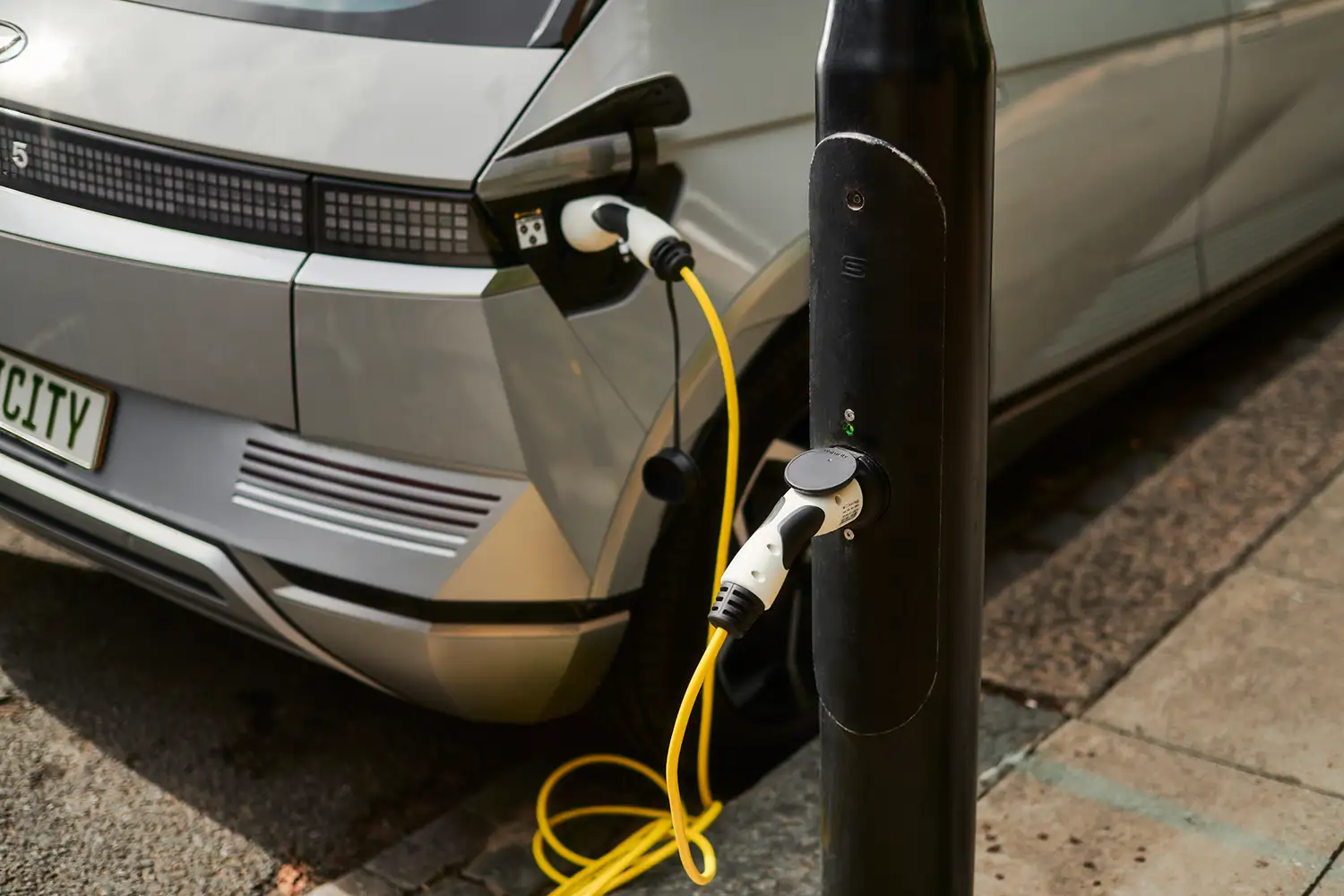 An EV is connected to an lamppost charging station from ubitricity, a company with expertise in rolling out public chargers for electric vehicles.