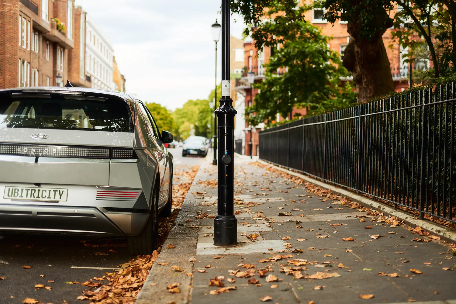 An EV is charging its battery at an ubitricity ac lamppost charger which are rolled-out in partnership with Siemens.