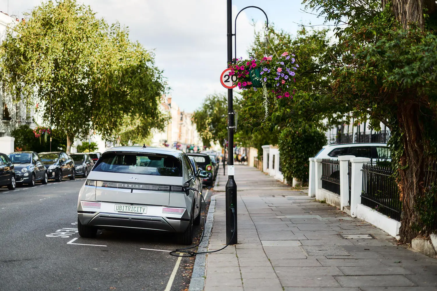 An electric vehicle is connected to a public lamppost charge point from ubitricity, the operator of the UK's largest charging network.