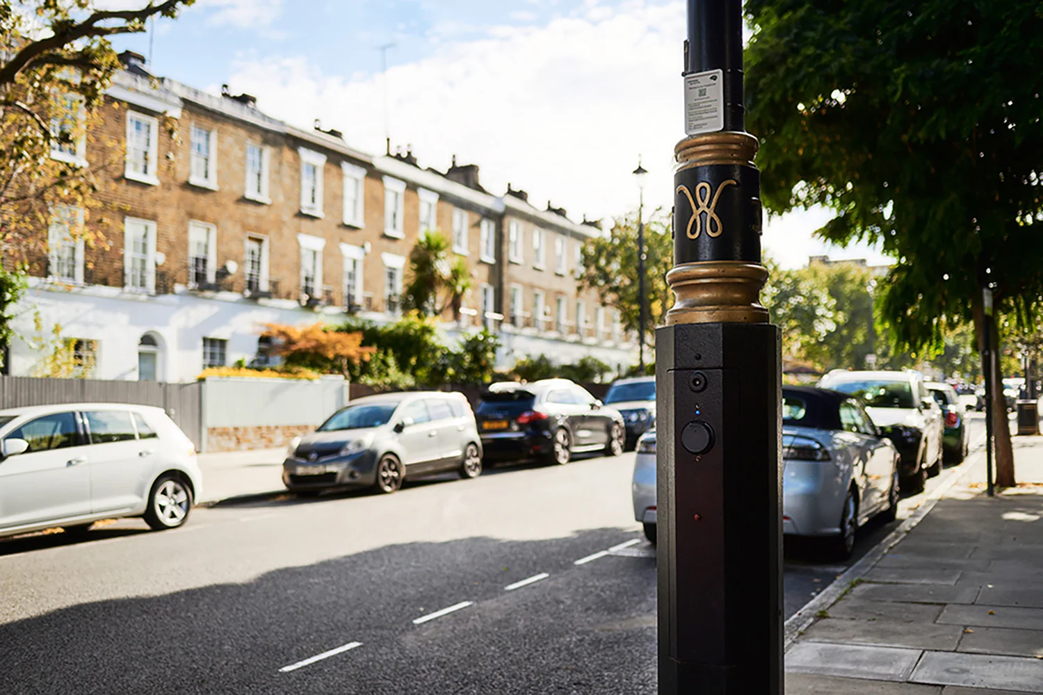 Detailed view on a public ubitricity lamppost charger, integrated into existing street furniture and part of the UK's largest public charging network