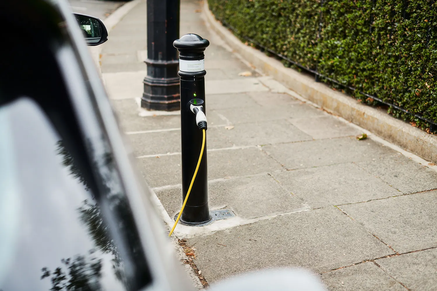 An electric vehicle is charging at a bollard from ubitricity, a company Siemens invested in in 2017.