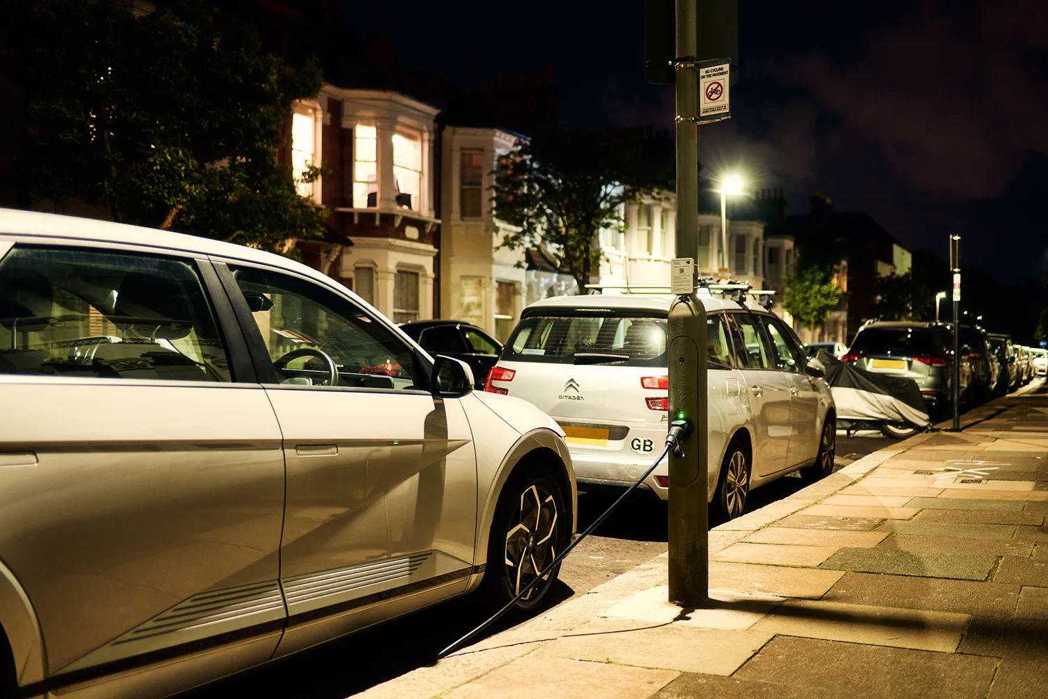 An electric vehicle is charging at a new ubitricity lamppost charging station in Richmond, London, UK.